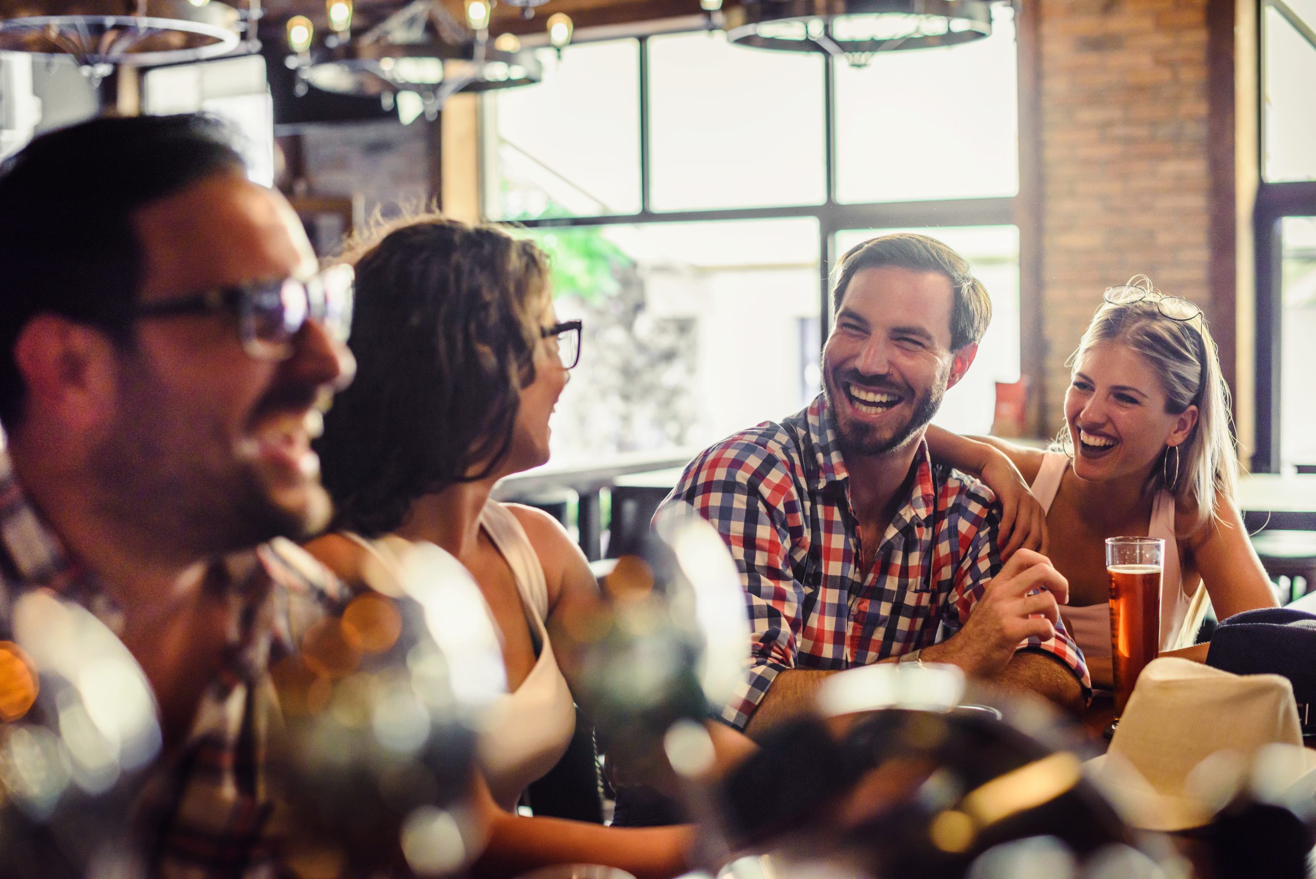 Happy friends having fun at bar - Young trendy people drinking b
